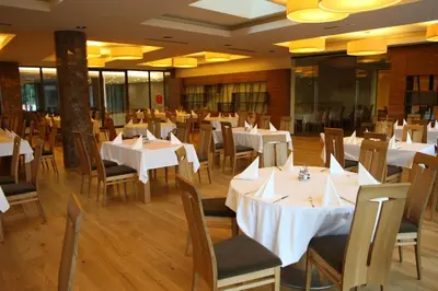 a dining room with white tables and chairs at Hotel BIOTERME Mala Nedelja in Ljutomer