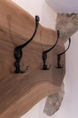 a wooden cutting board with two black wires on it at Apartma Oleander in Kobarid
