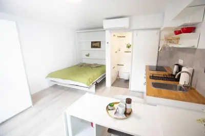 a small kitchen with a bed in a room at Apartment Studio Green in Ljubljana