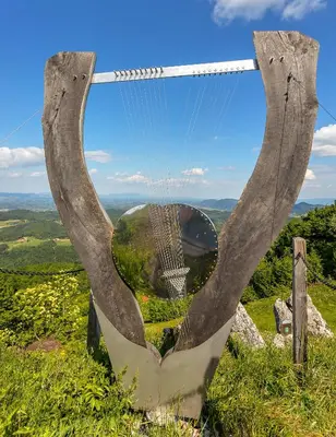 a large metal sculpture of a view from the top of a hill at Apartmaji Kunej pod Gradom with sauna in Podsreda