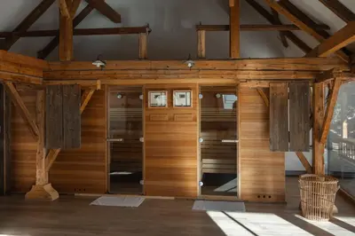 a large room with wooden walls and wooden beams at Herbal Glamping Resort Ljubno in Ljubno