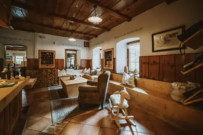 a living room with a couch and a table at Herbal Glamping Resort Ljubno in Ljubno