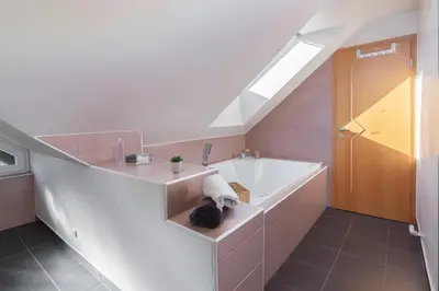 a bathroom with a sink and a bath tub at Relax Room Bohinjska Bistrica in Bohinj