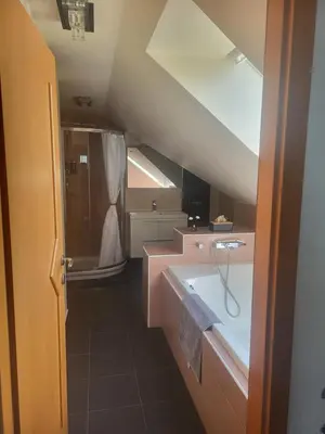 a bathroom with a sink and a bath tub at Relax Room Bohinjska Bistrica in Bohinj