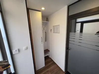 a hallway with a door leading to a walk in closet at Apartments KrAnJ - Family apartment Jurček in Kranj