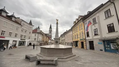 a large fountain in the middle of a city street at Apartments KrAnJ - Family apartment Jurček in Kranj