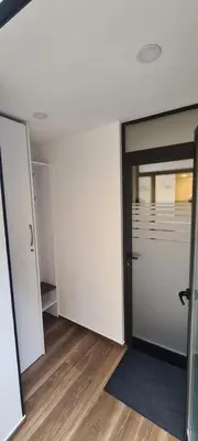 an empty room with a glass door and a floor at Apartments KrAnJ - Family apartment Jurček in Kranj