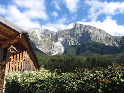 a view of the mountains from a house at Apartma Lovriž in Kobarid