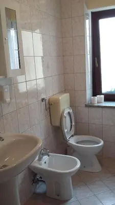 a bathroom with a toilet and a sink at Apartma Lovriž in Kobarid