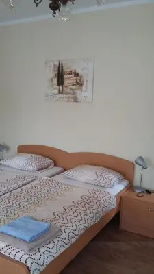 a bedroom with a bed and a picture on the wall at Apartma Lovriž in Kobarid