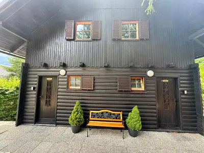 a house with a bench in front of it at Hiša Jelka in Kranjska Gora