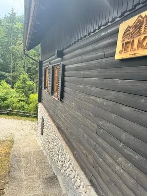a black building with a sign on the side of it at Hiša Jelka in Kranjska Gora