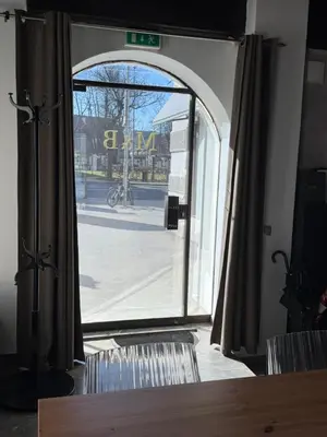 an open glass door with a view of a street at Historic studio apartment beneath the Ljubljana castle in the old city centre in Ljubljana