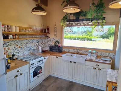 a kitchen with white cabinets and a sink and a window at Škedenj pri Vili Trate in Križevci pri Ljutomeru