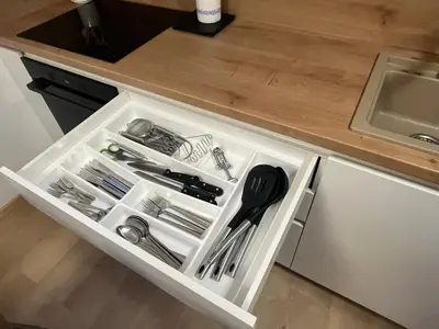 a white drawer with utensils in a kitchen at APARTMA BUQEZ-HOUSE 79 with Termal Riviera Čatež tickets in Čatež ob Savi