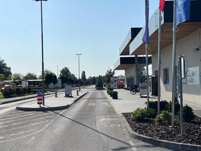 an empty street in front of a gas station at APARTMA BUQEZ-HOUSE 79 with Termal Riviera Čatež tickets in Čatež ob Savi