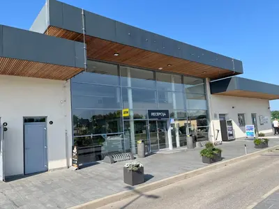 a store front with a large glass building at APARTMA BUQEZ-HOUSE 79 with Termal Riviera Čatež tickets in Čatež ob Savi