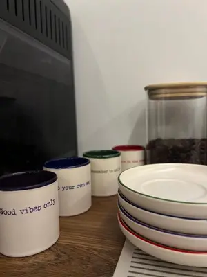 a group of bowls and plates sitting on a table at Kolodvor 1870 - Old Town Apartment Kranj in Kranj