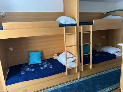 two bunk beds in a room with two children in them at Apartma Bučko in Bohinj