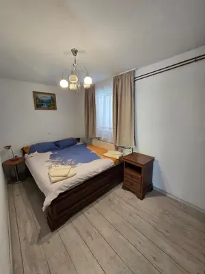 a bedroom with a bed and a table and a window at Pri tetki in Kranj