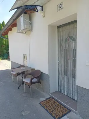 a table and chairs sitting outside of a building at Pri tetki in Kranj