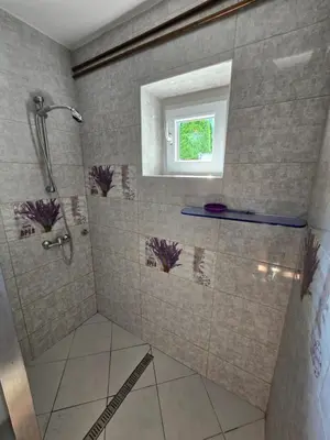 a bathroom with a shower and a window at Pri tetki in Kranj