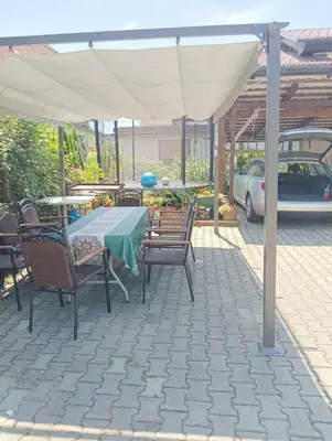 a patio with a table and chairs under a canopy at Pri tetki in Kranj