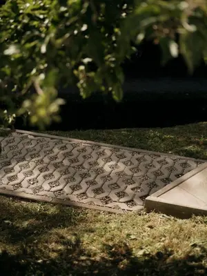 a gravestone in the grass in a yard at Peak & Pause in Bistrica pri Limbušu