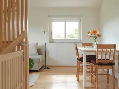 a dining room with a table and chairs and a window at Peak & Pause in Bistrica pri Limbušu