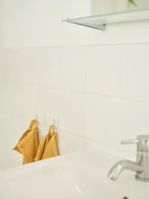 a bathroom with a towel rack with a sink at Peak & Pause in Bistrica pri Limbušu