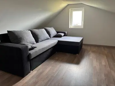 a living room with a couch and a window at Apartment Haloze in Videm pri Ptuju