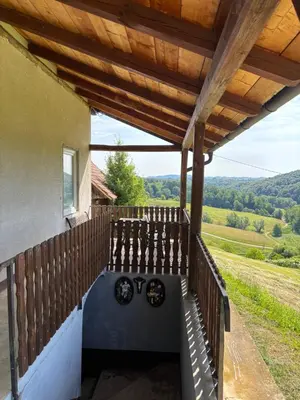 a porch of a house with a wooden fence at Apartment Haloze in Videm pri Ptuju