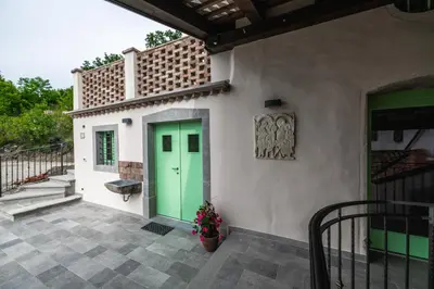 a green door on the side of a house at House Dorče in Kojsko