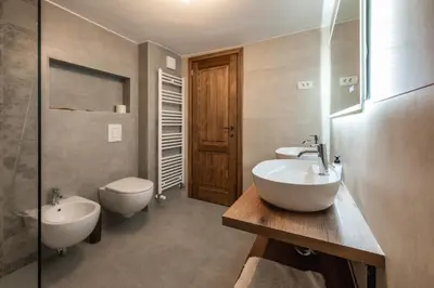 a bathroom with two sinks and a toilet at House Dorče in Kojsko