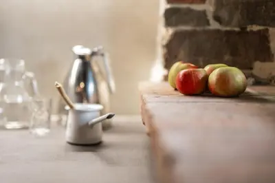 a group of apples sitting on a counter with a cup at House Dorče in Kojsko