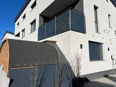 a white building with a black roof at Private SPA with jacuzi, sauna & EV charging in Kranj