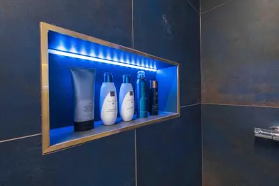 a shelf with bottles on it in a bathroom at Private SPA with jacuzi, sauna & EV charging in Kranj