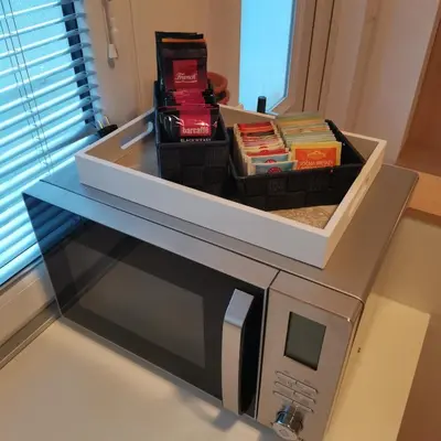 a microwave with a box on top of it at Apartment Swan in Bled