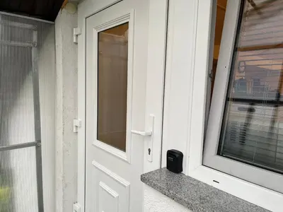 a white door with a window on a house at Apartment Swan in Bled