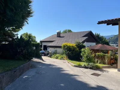 a house with a driveway in front of a house at Apartment Swan in Bled