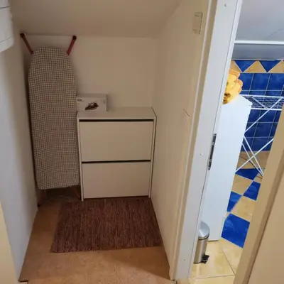 a small room with a table and a radiator at Apartment Swan in Bled