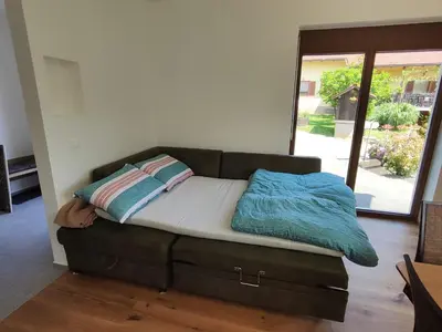 a couch with two pillows on it in a living room at Apartment Ratek in Ivanjkovci