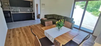 a living room with a table and a couch at Apartment Ratek in Ivanjkovci