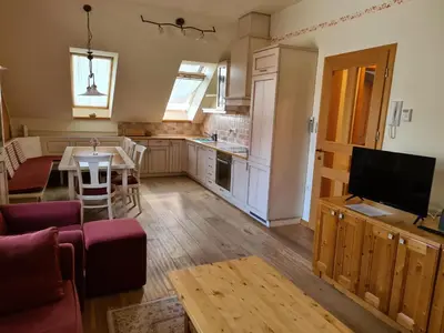 a kitchen with a living room and a dining room at Apartmaji Sitar in Ribnica na Pohorju