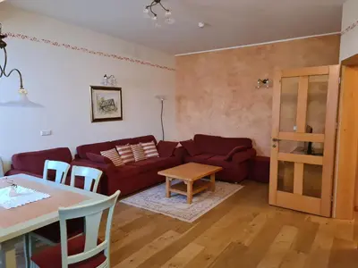 a living room with a couch and a table at Apartmaji Sitar in Ribnica na Pohorju