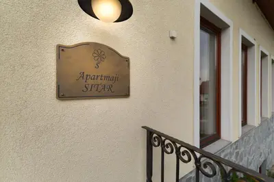 a sign for a restaurant on the side of a building at Apartmaji Sitar in Ribnica na Pohorju