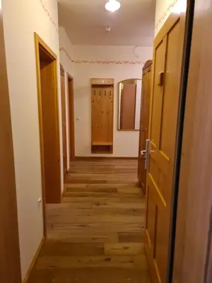 an empty hallway with wooden floors and doors at Apartmaji Sitar in Ribnica na Pohorju