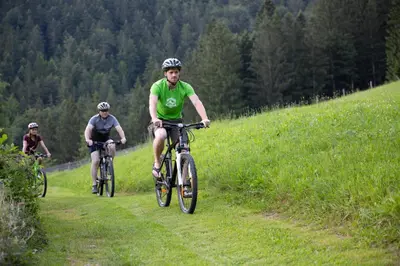 a group of people riding bikes down a hill at Turistična Kmetija Zgornji Zavratnik in Luče