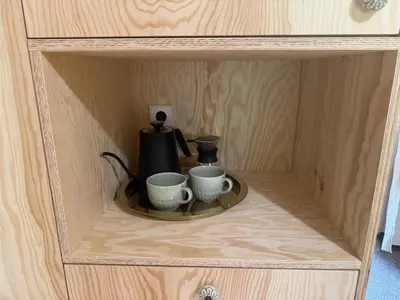 a wooden cabinet with two cups and a tea kettle at Telaj Residence - Cosy Cabins near Bovec, Soča Valley in Bovec