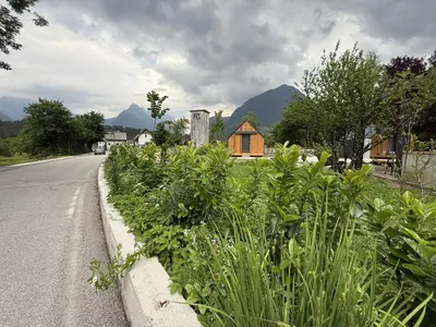 a small wooden house on the side of a road at Telaj Residence - Cosy Cabins near Bovec, Soča Valley in Bovec